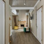 Warm and inviting chalet interior featuring wooden design and cozy fireplace setting.